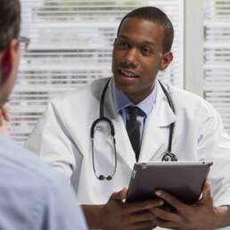 African American doctor with tablet and patient, horizontal