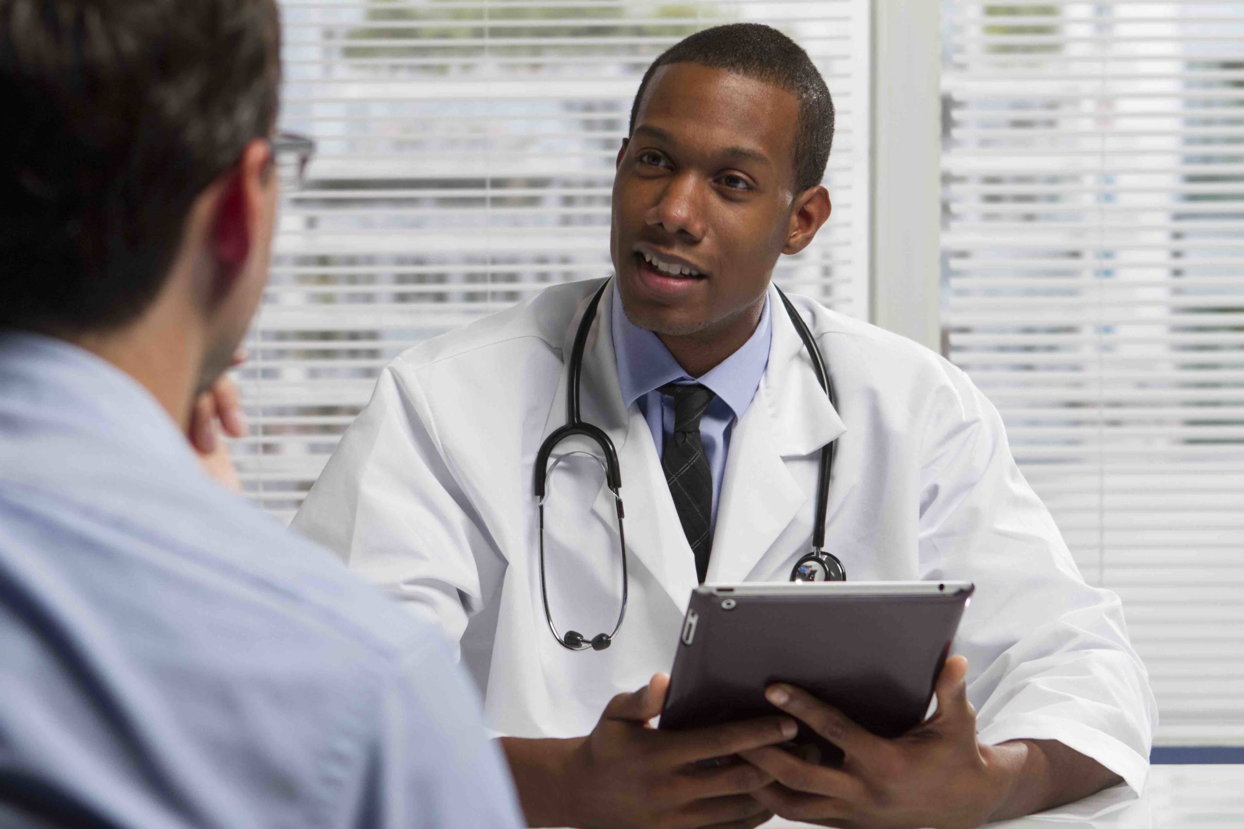 African American doctor with tablet and patient, horizontal