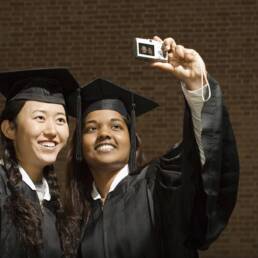 Two female graduates taking a photograph