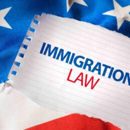 Immigration Law on notepaper and the US flag