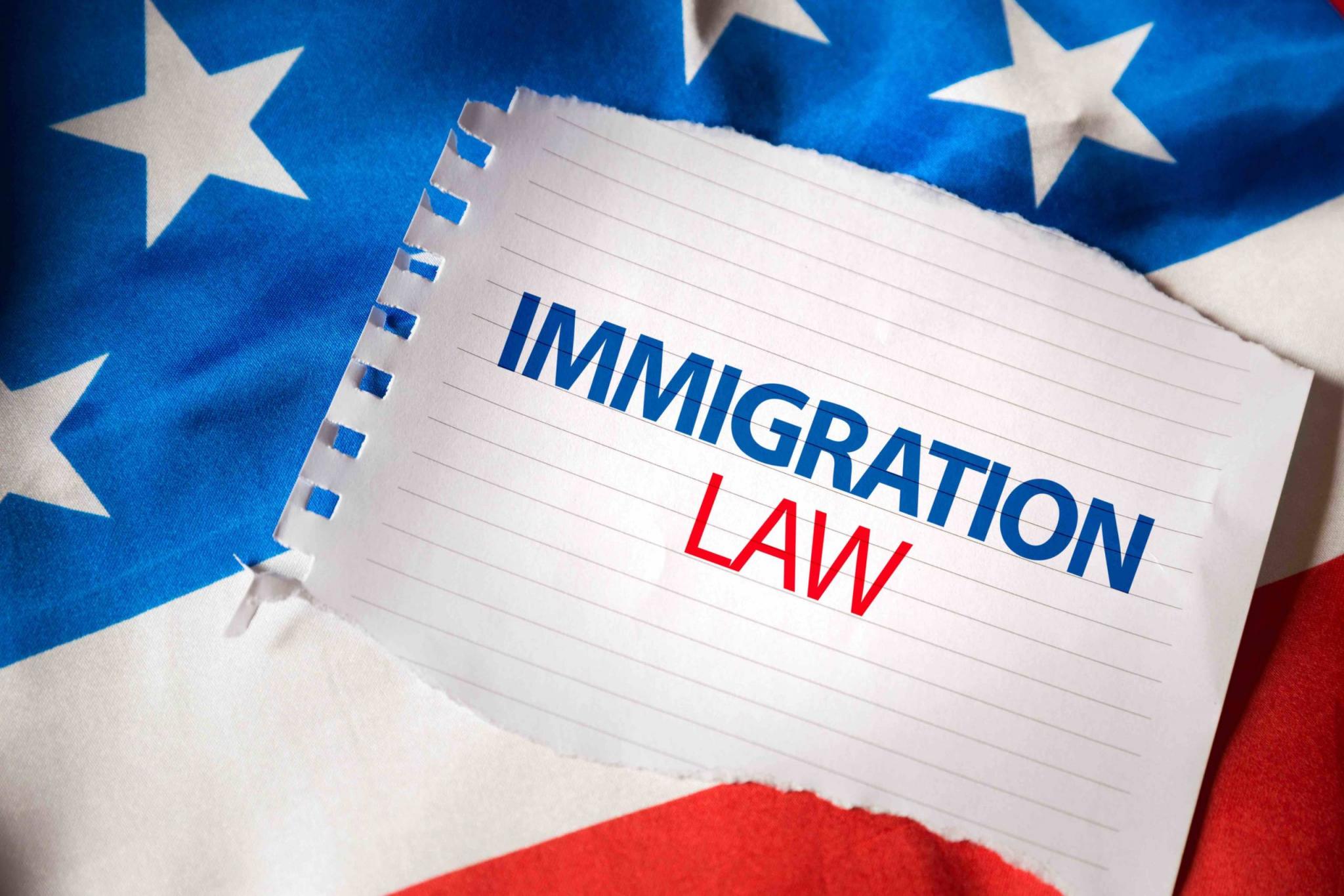 Immigration Law on notepaper and the US flag