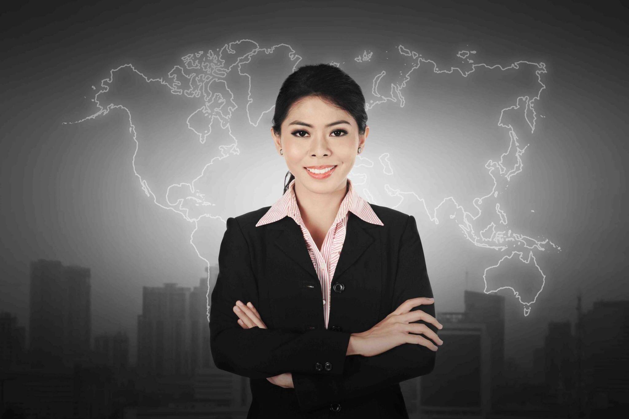 Business woman standing in front of world map