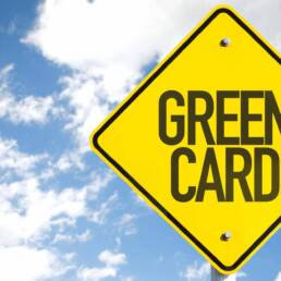 Green Card sign with sky background