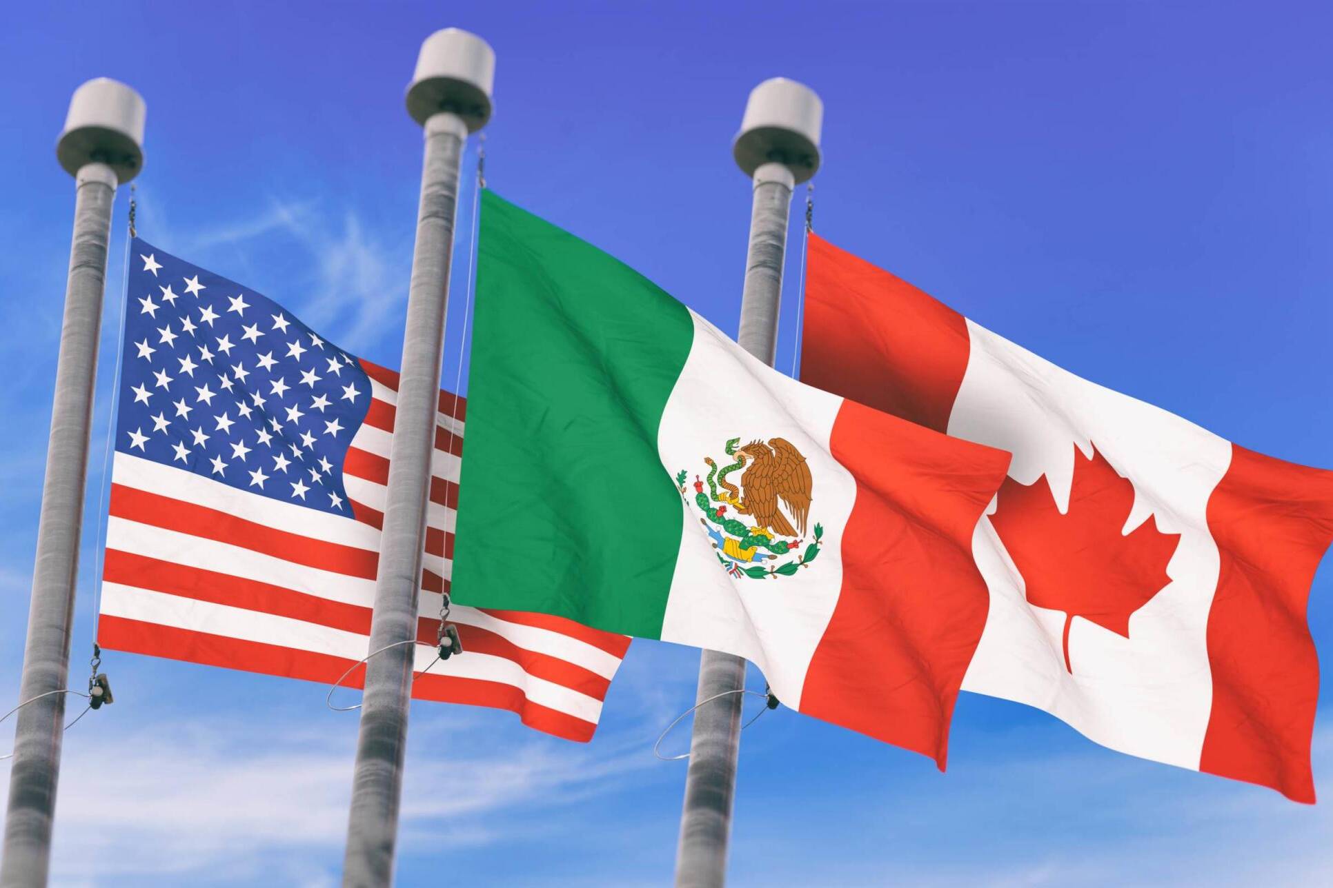 Canada, Mexico and US Flags over blue sky, conceptual image for Nafta agreement (3D rendered image)