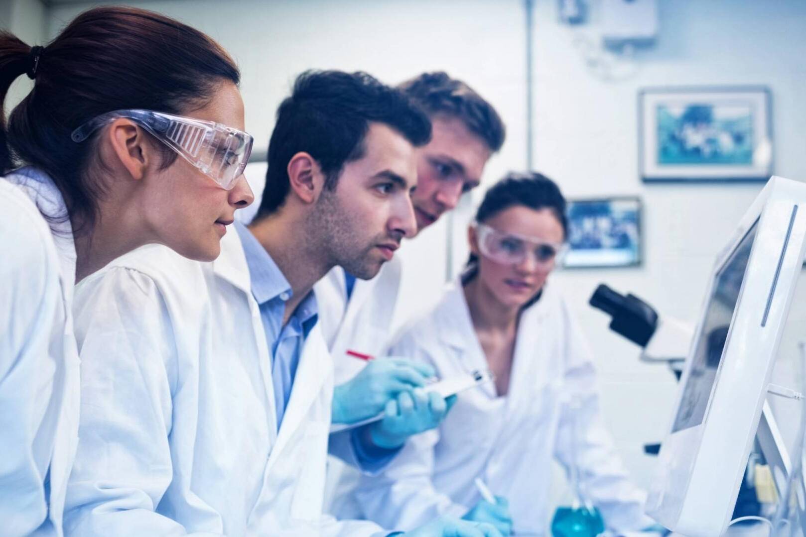 Serious researchers looking at computer screen in the lab