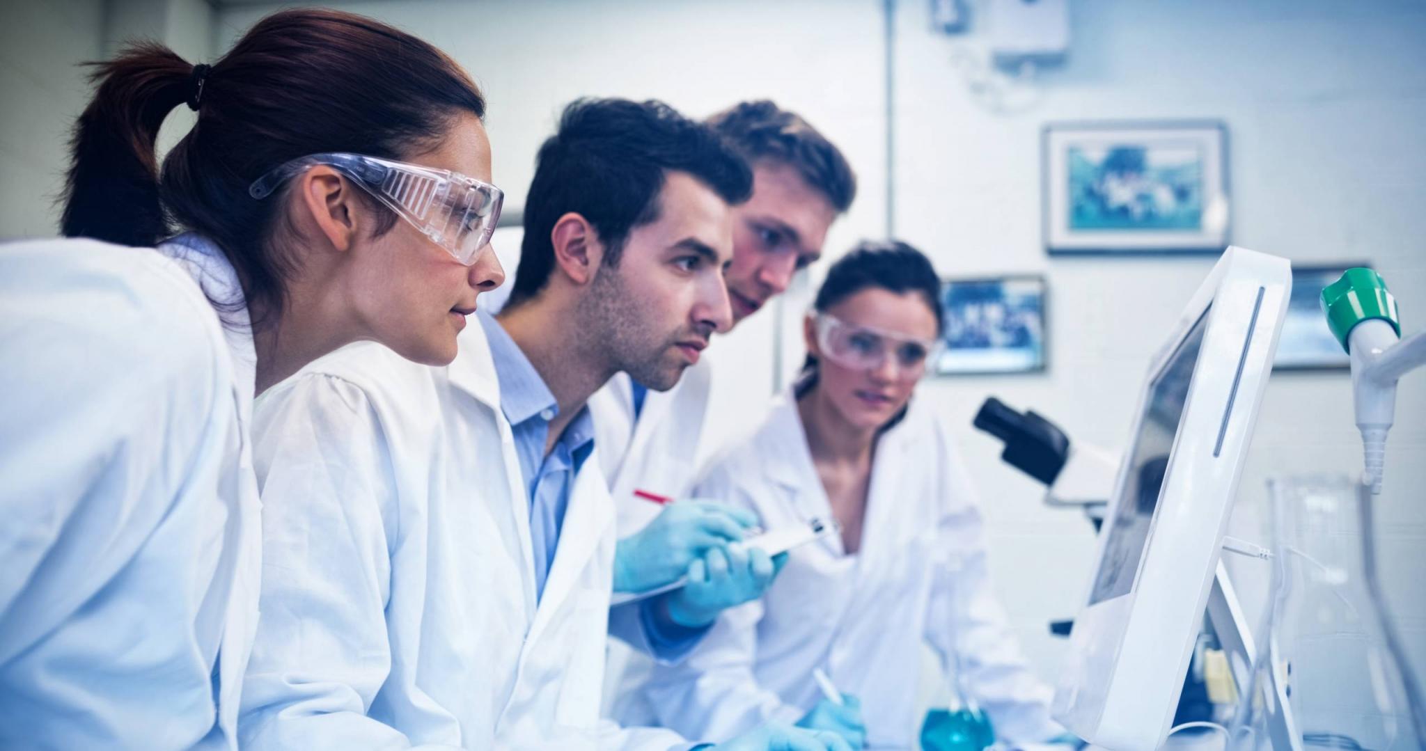 Serious researchers looking at computer screen in the lab