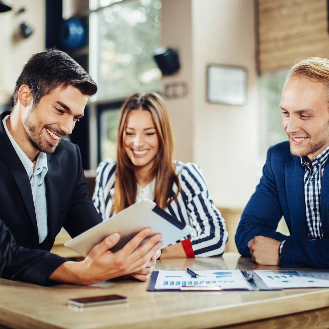 Small group of young people at a business meeting in a cafe