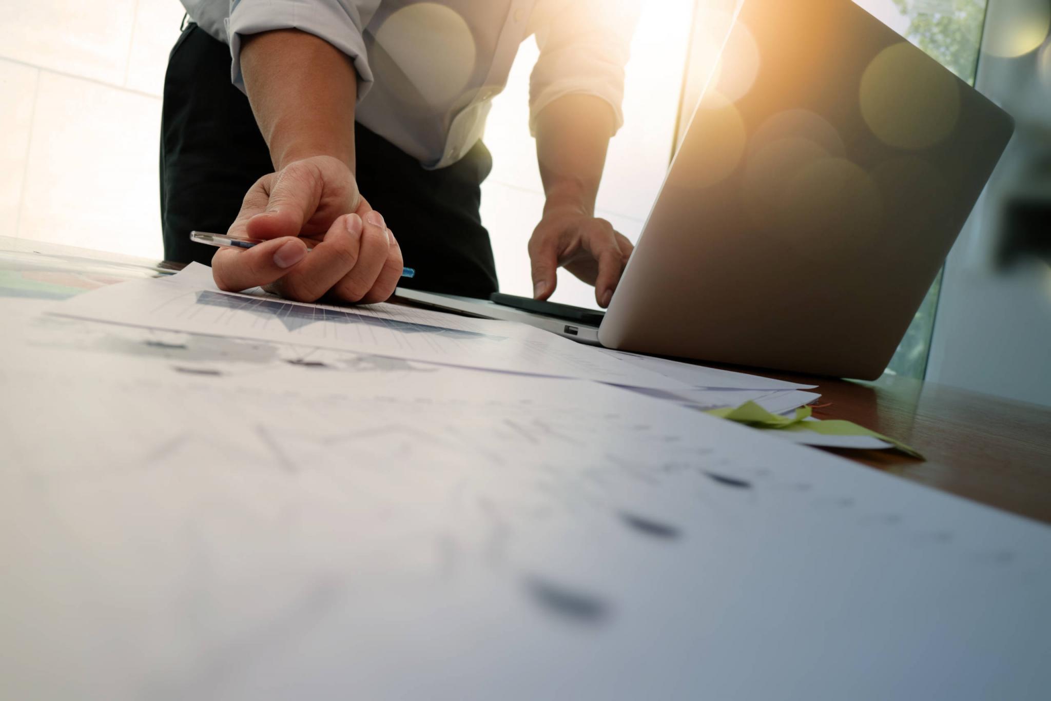 Double exposure of businessman hand working with new modern comp