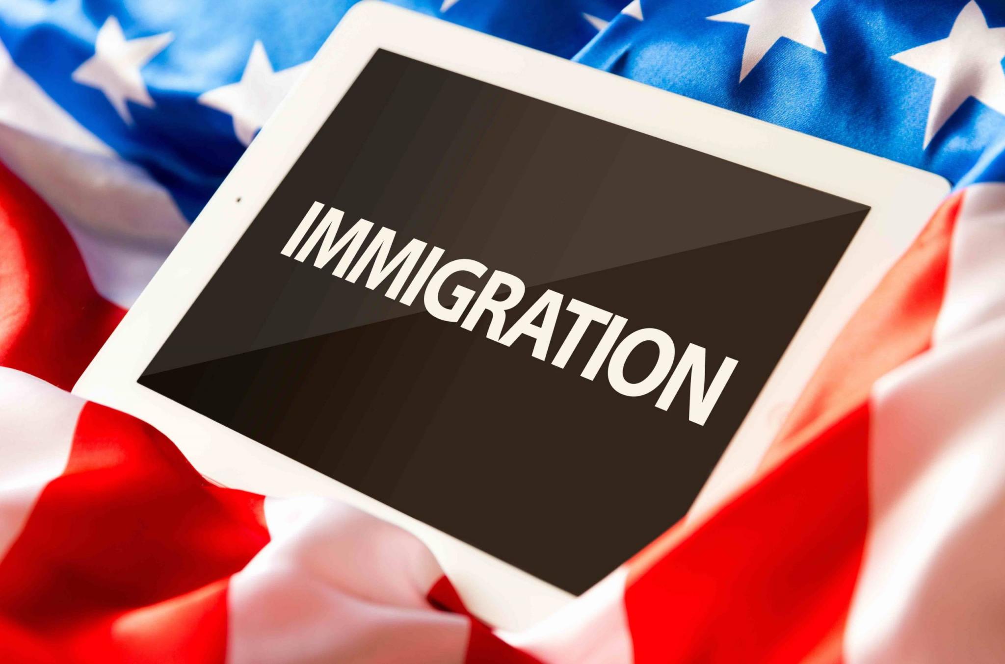 Immigration on tablet and the US flag