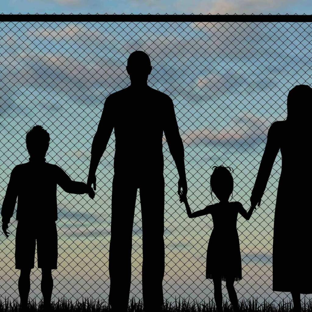 Silhouette of a refugees family with children