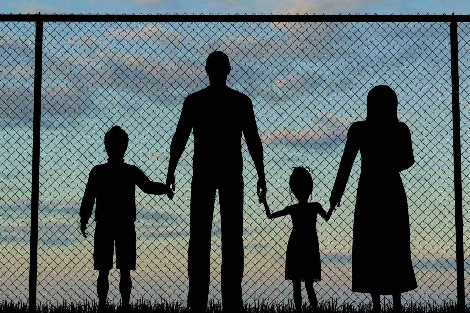 Silhouette of a refugees family with children