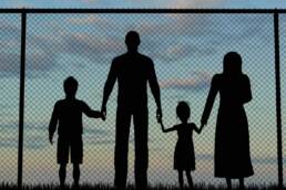 Silhouette of a refugees family with children