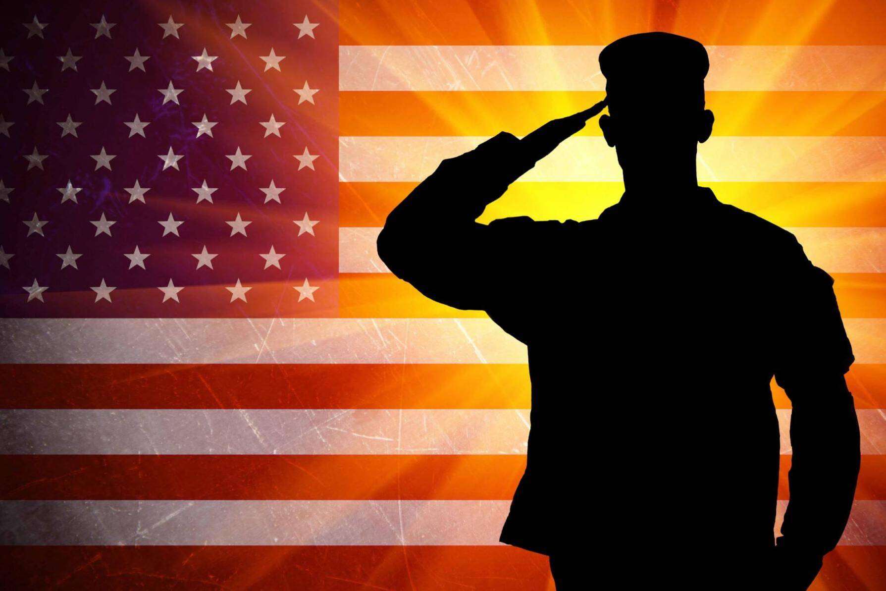 Proud saluting male army soldier on american flag background