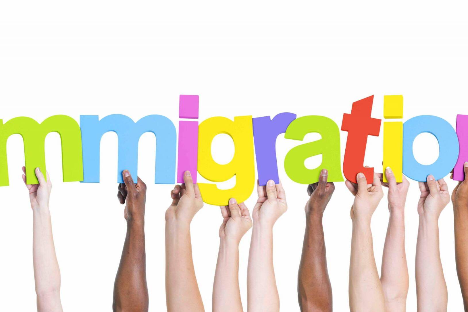 Diverse Hands Holding the Word Immigration