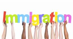 Diverse Hands Holding the Word Immigration