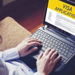 Woman doing electronic Visa Application in a laptop by internet.