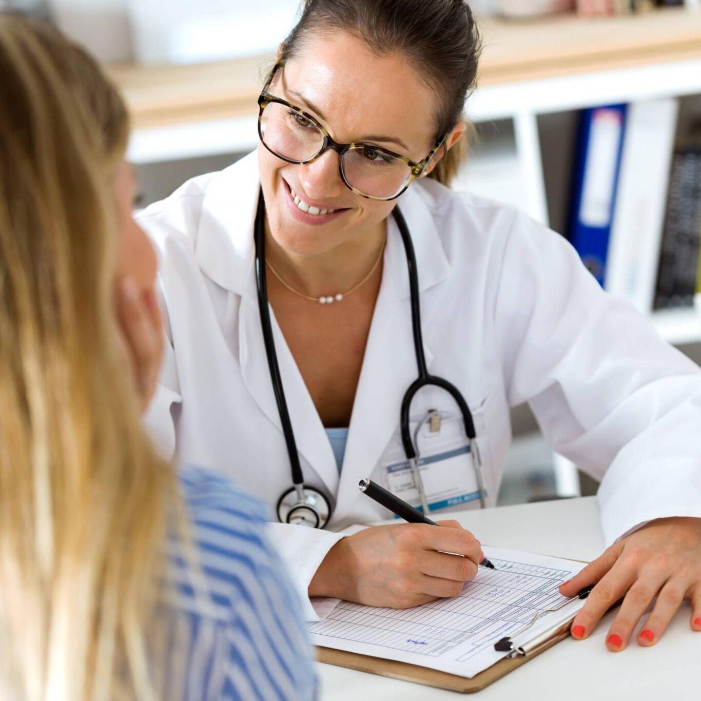 Female doctor explaining diagnosis to her patient.