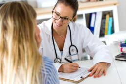 Female doctor explaining diagnosis to her patient.