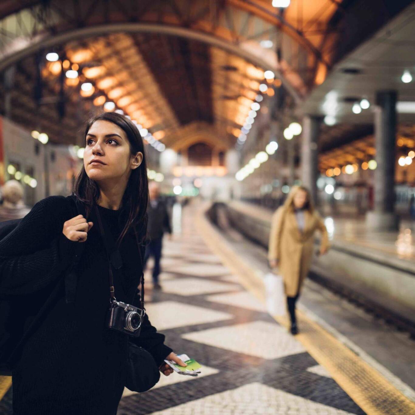 Female traveler searching for directions,waiting for the train/tram,using transportation in foreign country.Urban tourism.Low budget cheap ticket backpacking.Travel to the destination