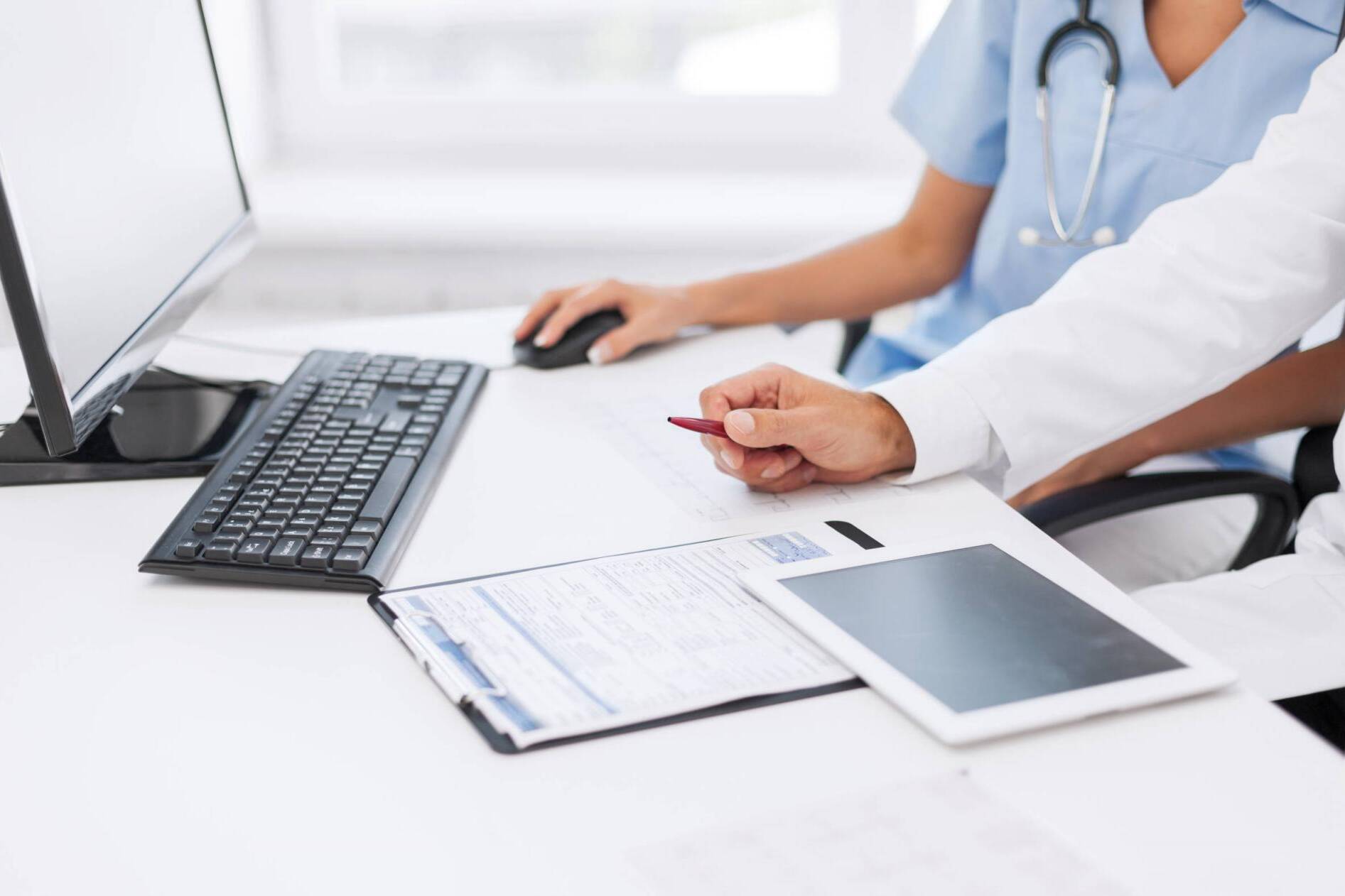 group of doctors looking at tablet pc