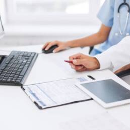 group of doctors looking at tablet pc