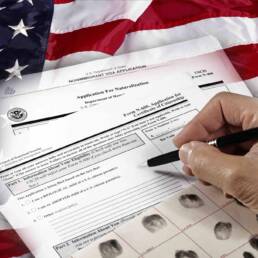 Man with American citizenship application on USA flag