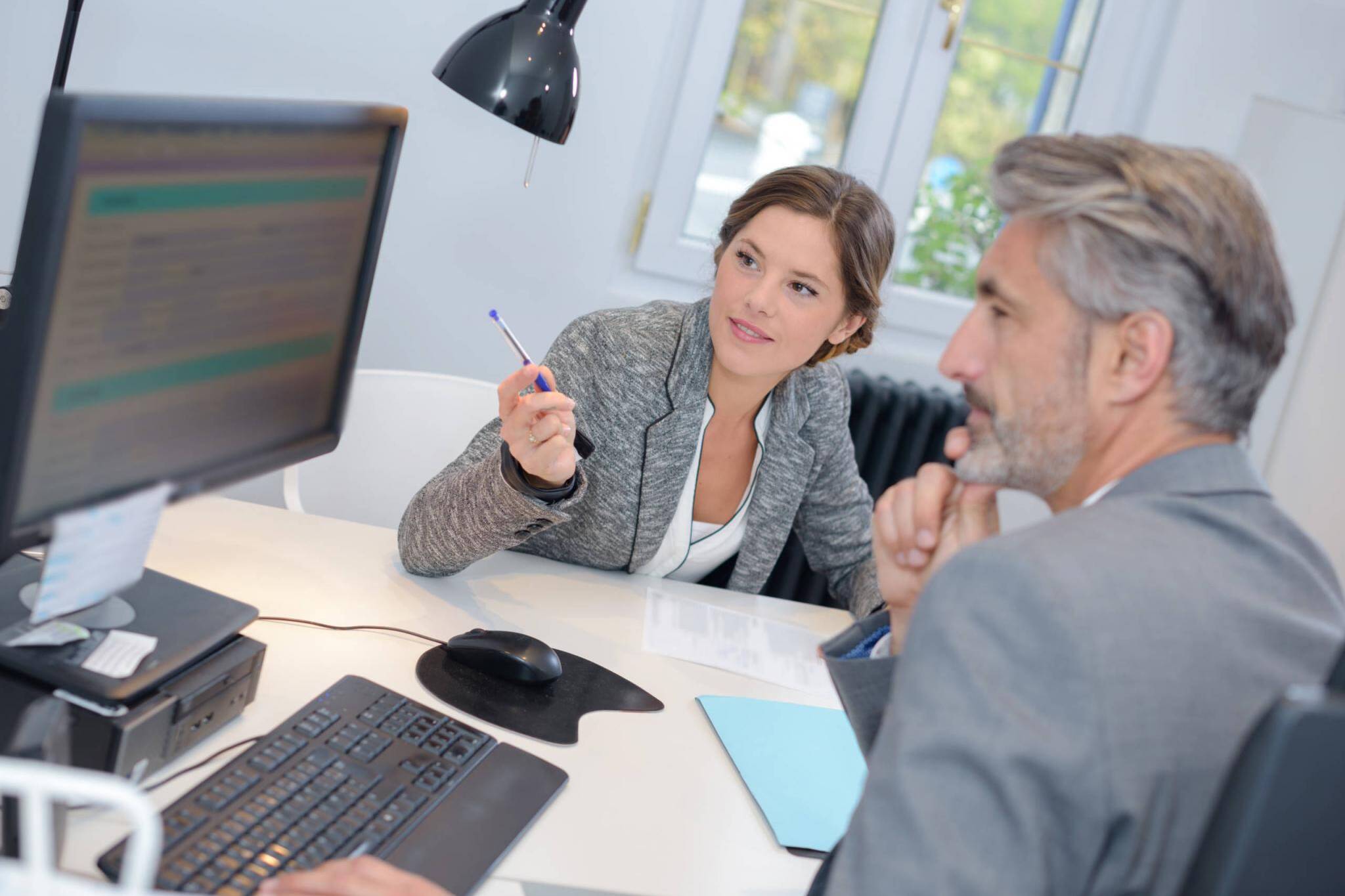 man dealing with a financial adviser at the bank