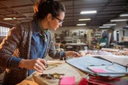 Picture of beautiful focused middle aged woman architect in her workshop working on new projects.