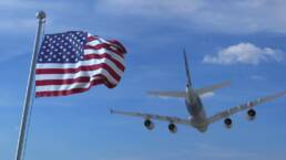 Commercial airplane landing behind waving American flag. Travel to the United States conceptual 3D rendering