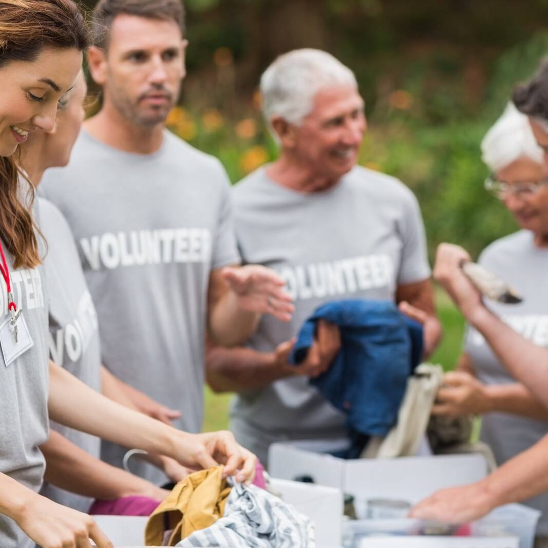 Happy volunteer looking at donation box