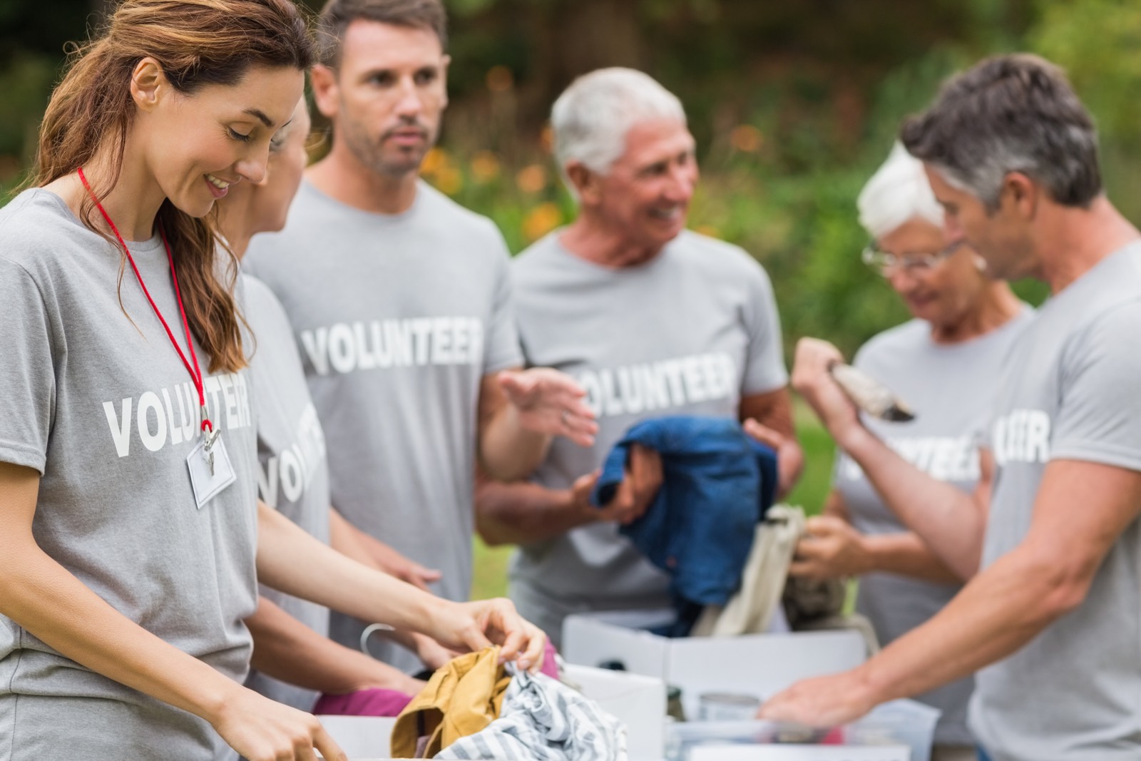 Happy volunteer looking at donation box