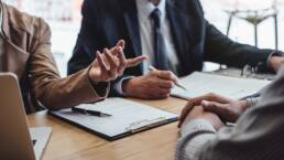 Two senior manager reading a resume during a job interview, Employer interviewing to ask young male job seeker for recruitment talking in office