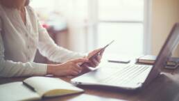 business woman hand working laptop computer on wooden desk.