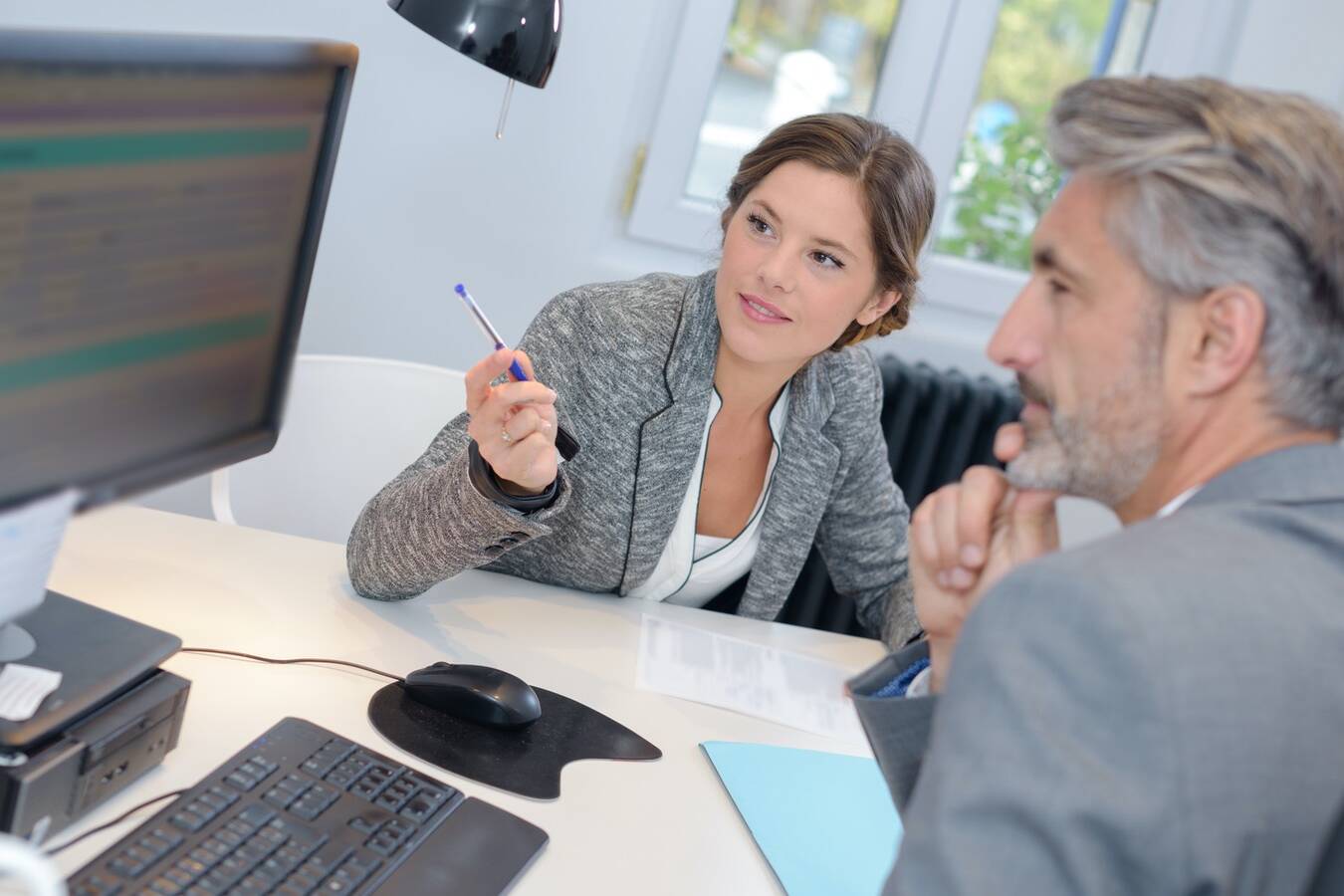 man dealing with a financial adviser at the bank