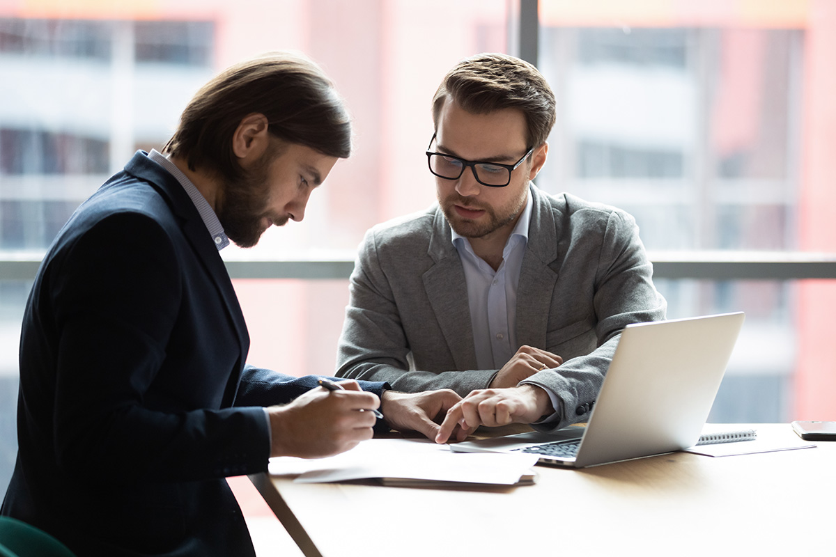 Two businessmen looking at paperwork