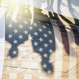 Shadows of People in a street and Flag of The USA as Background concept toned Picture